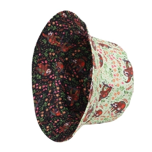 Double-sided bucket hat with light green sloth print and black floral reversible design