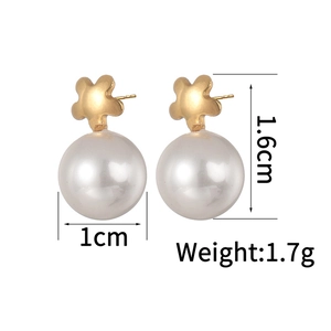 Detailed view of 18K gold plated pearl earrings with matte flower stud design
