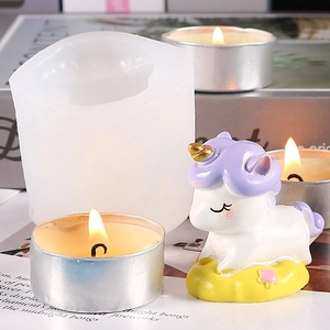 Unicorn shaped silicone mold for DIY candles and gypsum desktop decor on a magazine background
