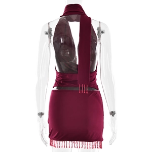 Détail du haut dos nu rouge vin et de la mini-jupe avec des accents de franges perlées