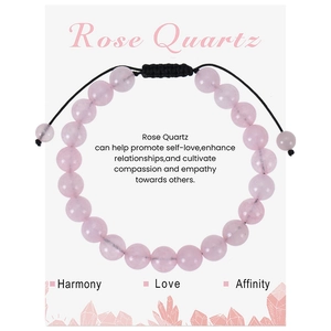 Detail of rose quartz beaded bracelet with adjustable black cord on a gift message card