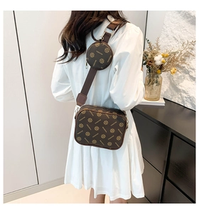 Detail of crossbody camera bag set featuring a small square pouch and round coin purse