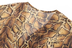 Detailed view of the crew neckline and semi-transparent brown leopard print fabric