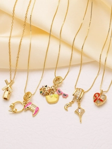 Macro view of 18k gold plated necklaces with heart and gamepad enamel pendants
