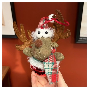 Close-up of reindeer Christmas ornament with red bell and plaid scarf details