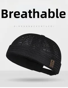 Detail of breathable large mesh fabric and vintage leather patch on black docker hat