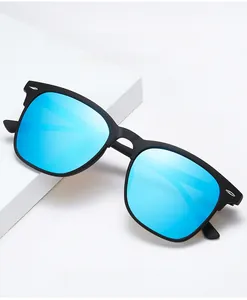 Detail of matte black sunglasses frame with blue mirrored lenses and silver rivets