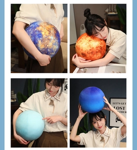 Detailed view of realistic planet plush pillows in various cosmic designs with a model