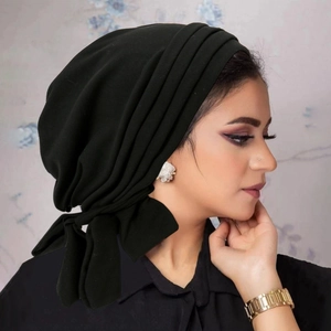 Detail view of black velvet headscarf showing side drapes and professional tie design