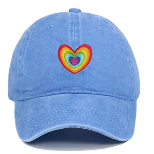 Detailed embroidery of rainbow heart on light blue washed cotton baseball cap