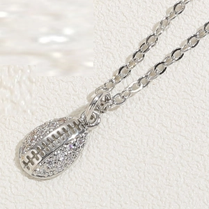 Close-up of silver rugby pendant with pavé-set clear cubic zirconia on minimalist chain