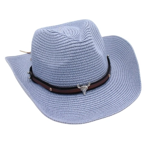 Detail of blue straw cowboy hat featuring a silver bull head metal ornament on band