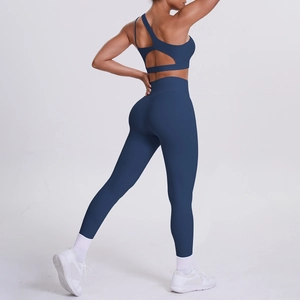 Detail of dark blue yoga set showing the open-back sports bra and high-waisted leggings