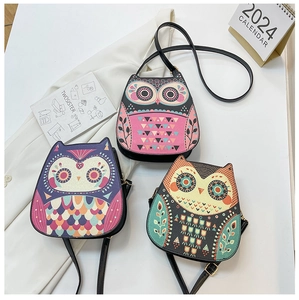 Close-up of owl-shaped PU crossbody bags with vibrant ethnic patterns and adjustable straps