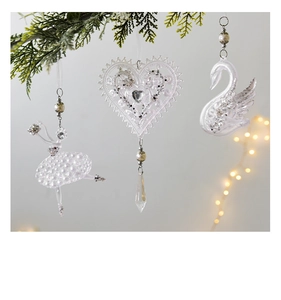 Hanging acrylic ballerina, heart, and swan ornaments with pearls on pine branches