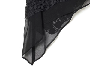 Detailed close-up of intricate black floral lace and sheer chiffon fabric stitching