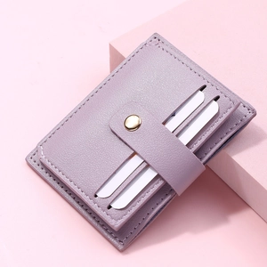 Detail of light purple slim card holder with lychee texture leather and metal snap closure