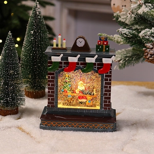 Close-up of a festive fireplace crystal ball with Santa scene and warm LED light effect