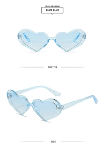 Detail view of heart-shaped blue sunglasses featuring light blue PC frames and lenses