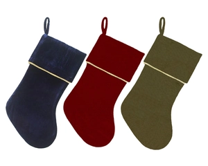 Three plush velvet Christmas stockings in red, blue, and green with golden rope trim