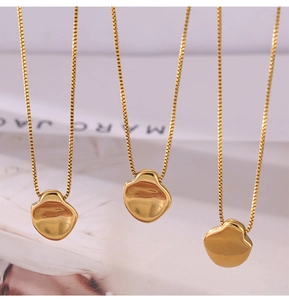 Three gold necklaces with mirror-polished irregular round pendants on box chains