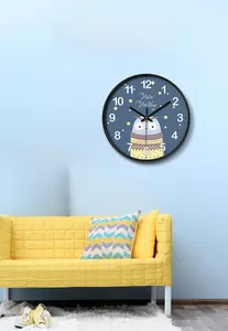Close-up of kids room wall clock featuring a cartoon owl design on a dark blue dial