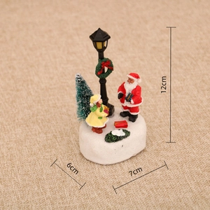 Front view of glowing Christmas miniature scene with Santa Claus and tree, size 12x7x6cm