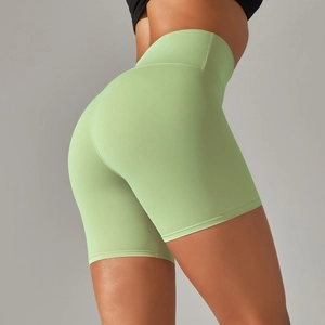 Detail view of high-waisted seamless yoga shorts showing light green brushed fabric texture
