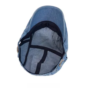 Internal structure of blue denim flat cap with reinforced stitching and metal buckle