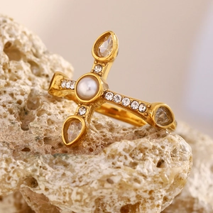 Detailed close-up of an 18K gold-plated cross ring with white pearls and sparkling zircons