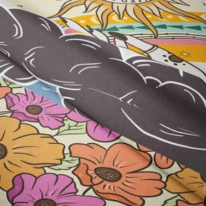 Detailed view of bohemian tapestry fabric with sun patterns and floral print texture