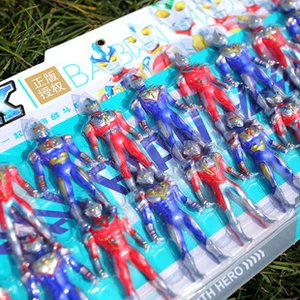 Detailed macro view of plastic action figure toy set arranged on green grass background