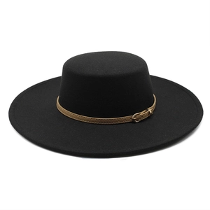 Detail of black wool flat top boater hat with a slim brown leather band and gold buckle