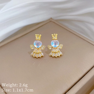 Detailed view of gold angel crown earrings with iridescent stones on white silk