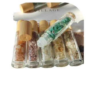 Essential oil glass bottles with natural crystal stones and textured wooden caps