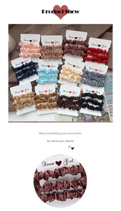 Detailed view of three-piece satin scrunchies sets on display cards in various colors