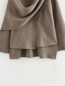 Detail of brown knitted asymmetrical scarf jacket showing textured wool blend fabric