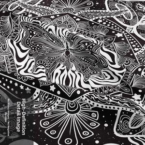 Close-up of black and white mandala tapestry fabric with intricate star and floral patterns