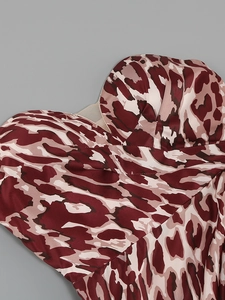 Detailed macro of leopard print satin fabric and cup structure on the party dress