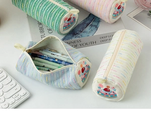 Detail of tweed pencil case with cute strawberry cake embroidery and a handy side strap