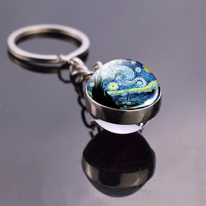 Detailed macro shot of glass dome keychain featuring Van Gogh's Starry Night artwork