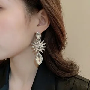 Long crystal drop earrings featuring floral pattern with silver-plated needle and clear stones