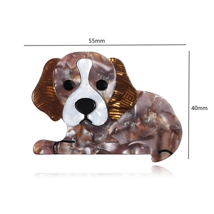 Detail view of a 55x40mm brown tortoiseshell dog brooch in polished acrylic resin