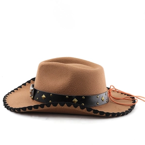 Detail of brown wool felt cowboy hat featuring bull head stud and whipstitch brim edges