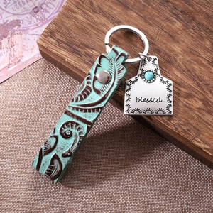 Vintage leather keychain with mint green texture and silver blessed tag with turquoise