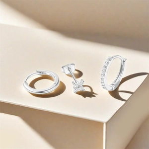 Macro detail of S925 sterling silver hoop earrings set showing the hallmark and zirconia