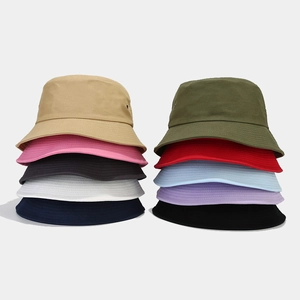Breathable cotton bucket hats in ten assorted colors stacked on a grey background