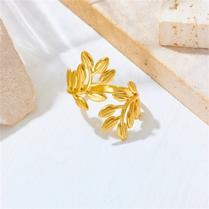 Detailed macro shot of a golden olive leaf open ring made of polished stainless steel