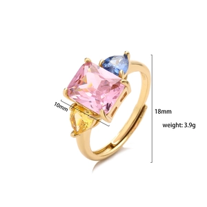Golden ring with pink, blue, and yellow zircons, size 18mm, weighing 3.9g on white background