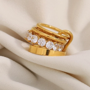 Macro detail of multi-layer 18K gold plated stainless steel ring with pavé zircons
